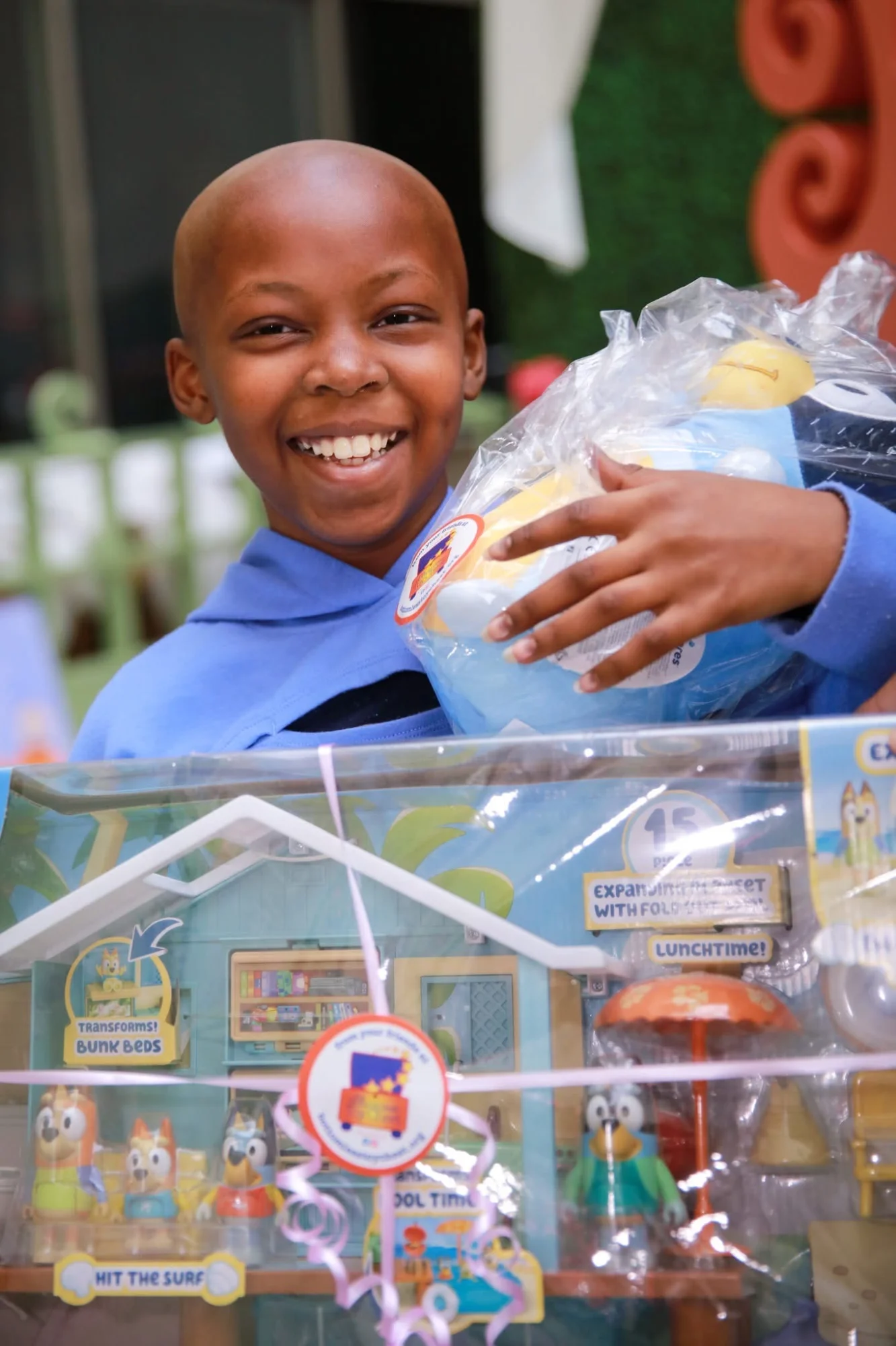 Child receiving toy from Bottomless Toy Chest